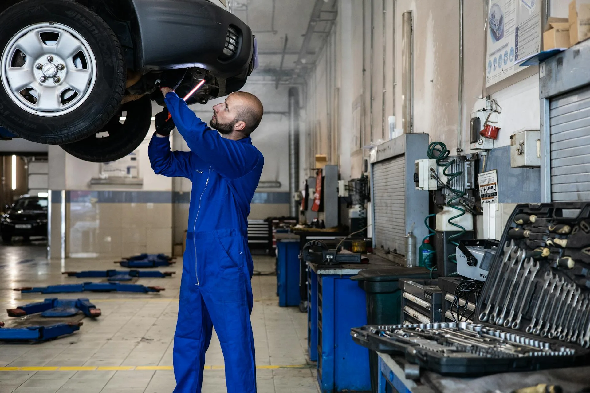Mechanic inspecting vehicle at Glen Eden Automotive